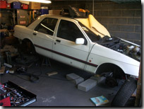 The Sierra jacked up to get the engine and gearbox out - Click for larger image
